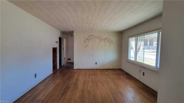 empty room featuring hardwood / wood-style flooring