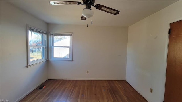 spare room featuring ceiling fan and dark wood-type flooring