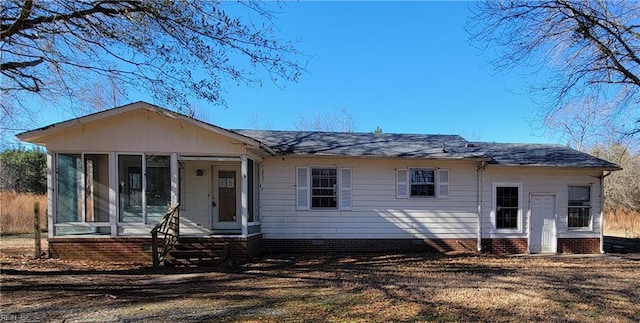 view of front of home with a sunroom and a front lawn