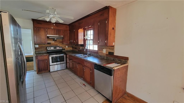 kitchen featuring appliances with stainless steel finishes, tasteful backsplash, ceiling fan, sink, and light tile patterned floors