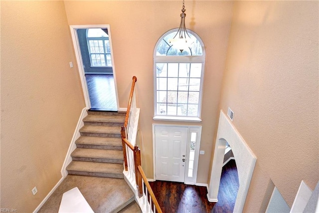 foyer with a towering ceiling and a healthy amount of sunlight