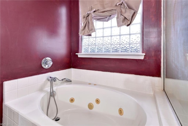 bathroom with a relaxing tiled tub