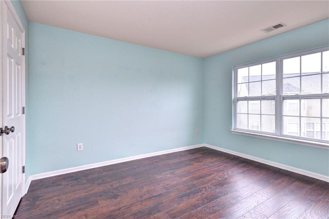 spare room with dark hardwood / wood-style flooring