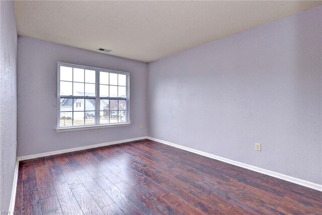 empty room featuring dark hardwood / wood-style flooring