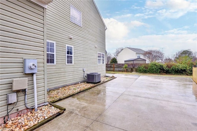 exterior space with central AC unit and a patio