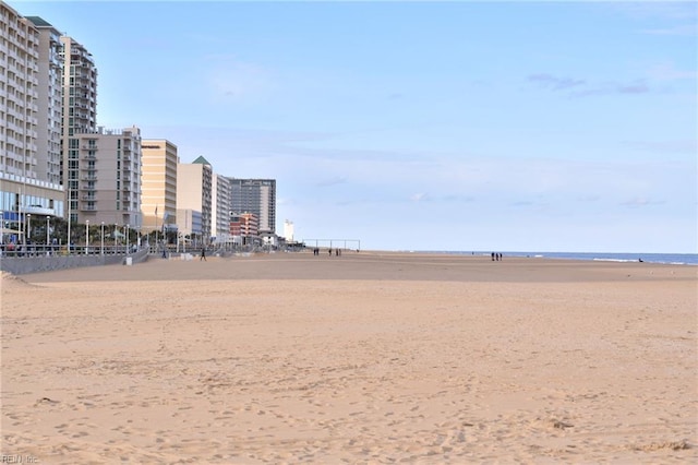 surrounding community featuring a beach view and a water view