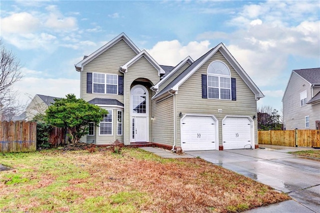 view of property featuring a garage and a front yard