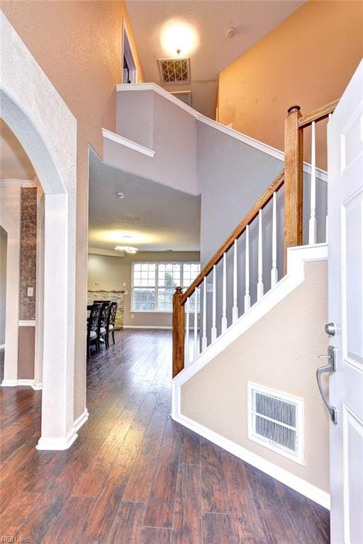 entrance foyer featuring dark hardwood / wood-style flooring and a high ceiling