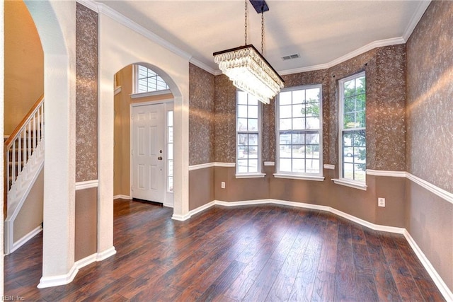 foyer with dark hardwood / wood-style flooring, a notable chandelier, and ornamental molding