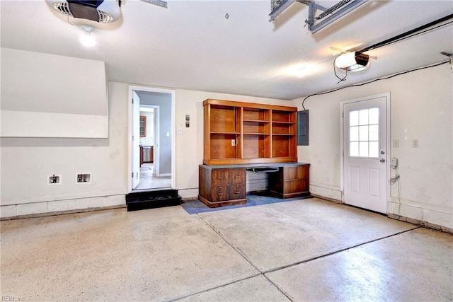 garage with electric panel and a garage door opener