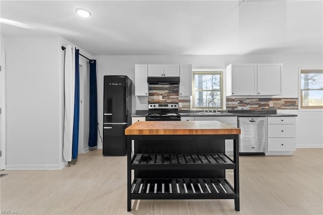 kitchen with butcher block countertops, white cabinetry, sink, and appliances with stainless steel finishes