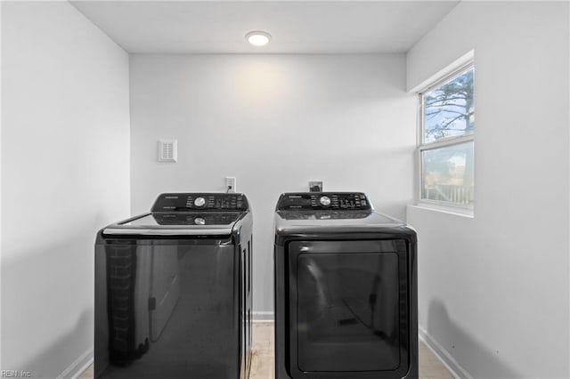 laundry area featuring washer and clothes dryer and wood-type flooring