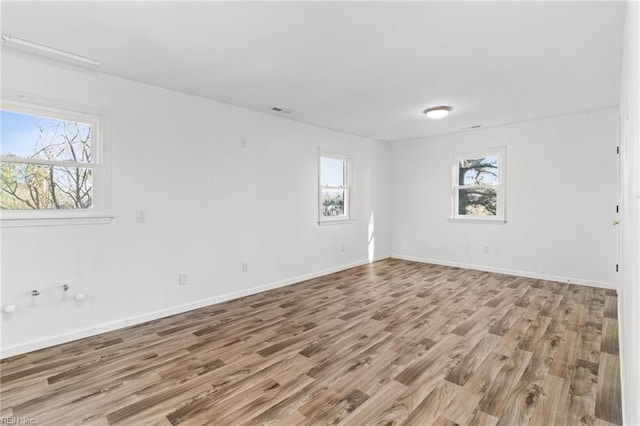 spare room featuring light hardwood / wood-style flooring