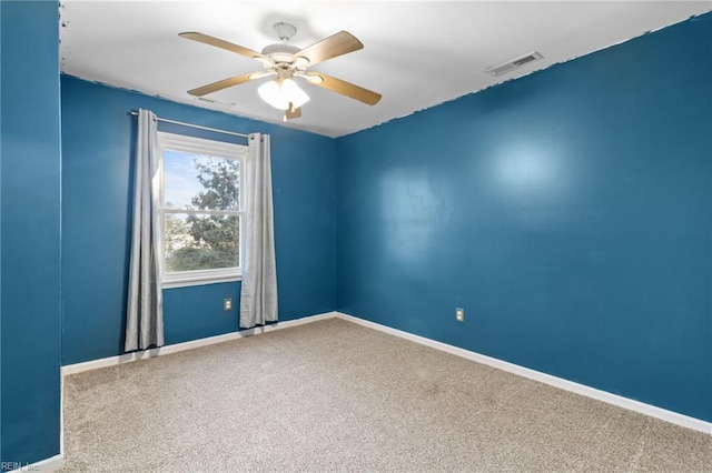 carpeted spare room featuring ceiling fan