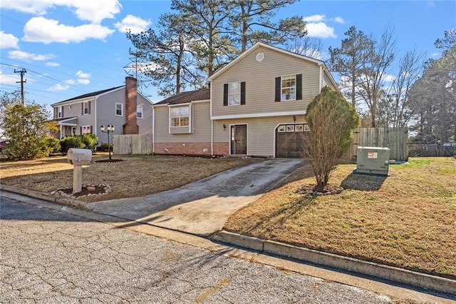 split level home with a front yard and a garage