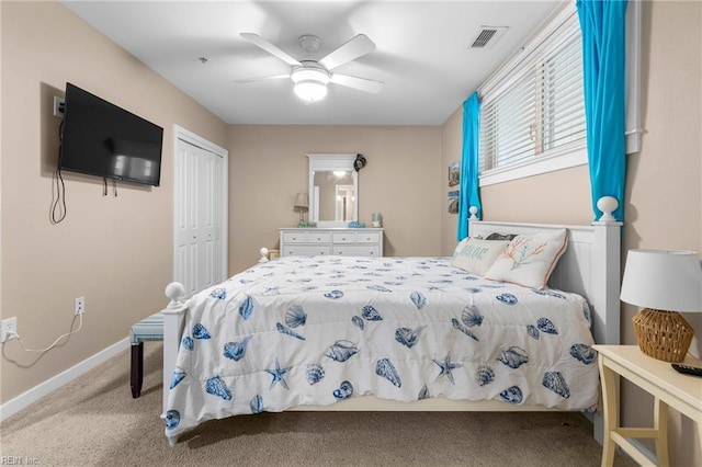 carpeted bedroom with ceiling fan and a closet