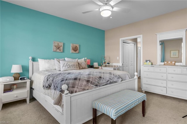 bedroom with ceiling fan, a closet, and light carpet