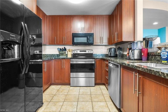 kitchen featuring black appliances, light tile patterned floors, sink, and dark stone counters