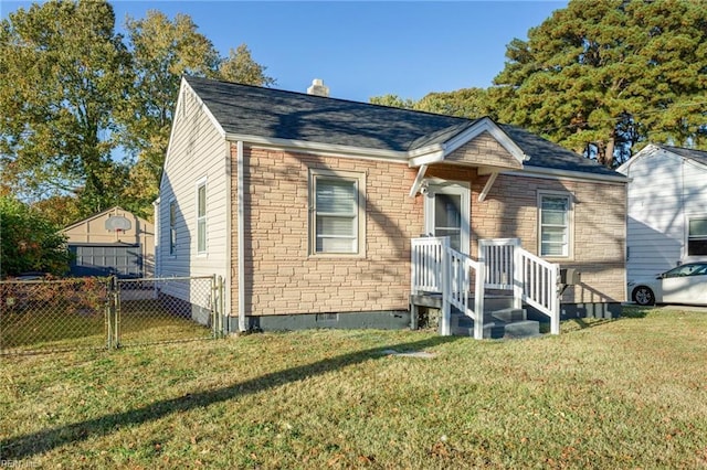 bungalow-style home with a front yard