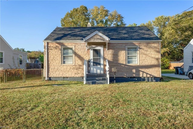 bungalow-style home featuring a front yard