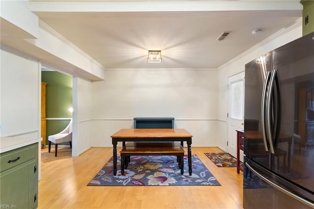 office with light wood-type flooring and ornamental molding