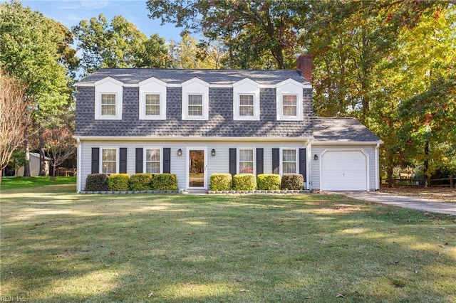 cape cod home featuring a garage and a front lawn