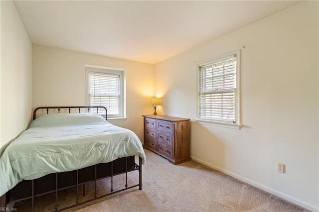 bedroom featuring light carpet