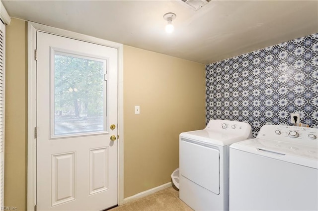 washroom featuring washer and dryer and light carpet