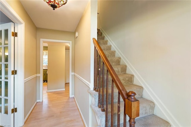 staircase with wood-type flooring