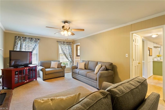 carpeted living room featuring ceiling fan and ornamental molding