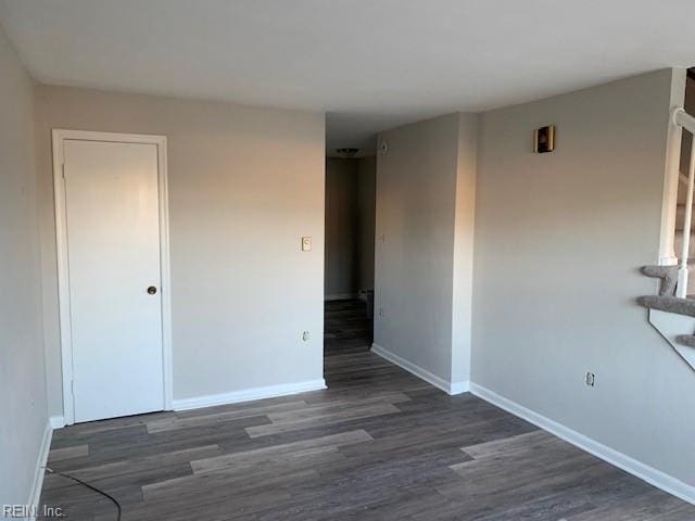 unfurnished room featuring dark hardwood / wood-style flooring