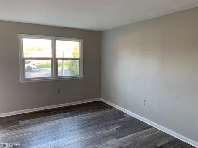 spare room with dark hardwood / wood-style floors