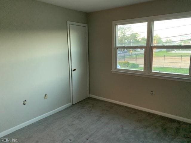 empty room featuring carpet flooring and a healthy amount of sunlight