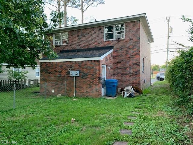 rear view of property with a lawn