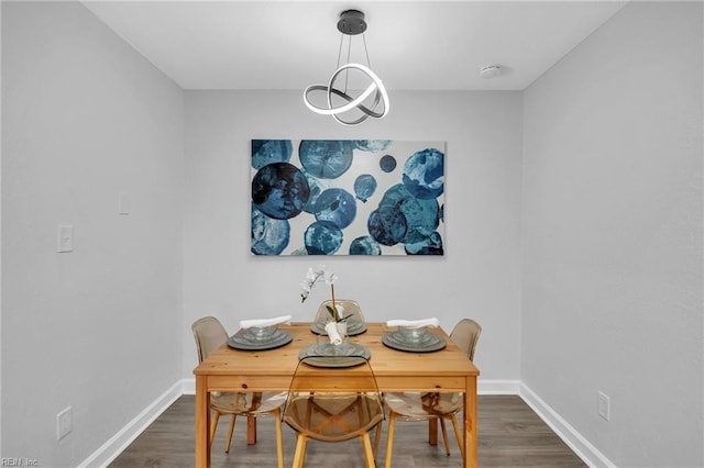 dining space with dark hardwood / wood-style floors