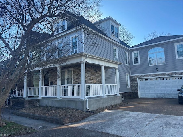 view of front of home featuring a porch and a garage