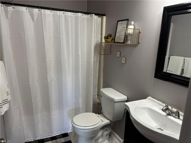 bathroom with a shower with shower curtain, toilet, and sink