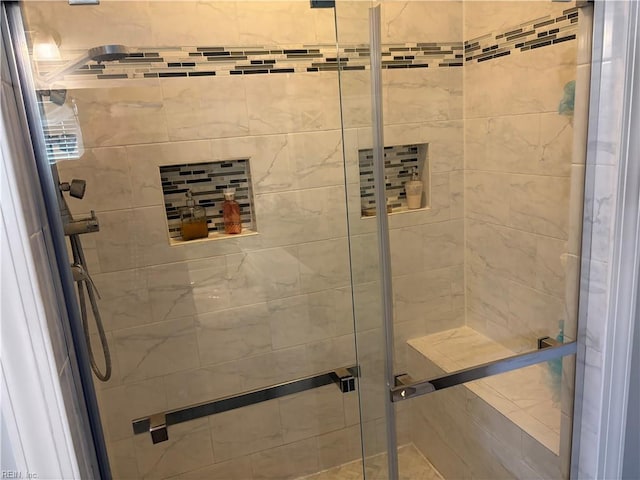 bathroom with a shower with door