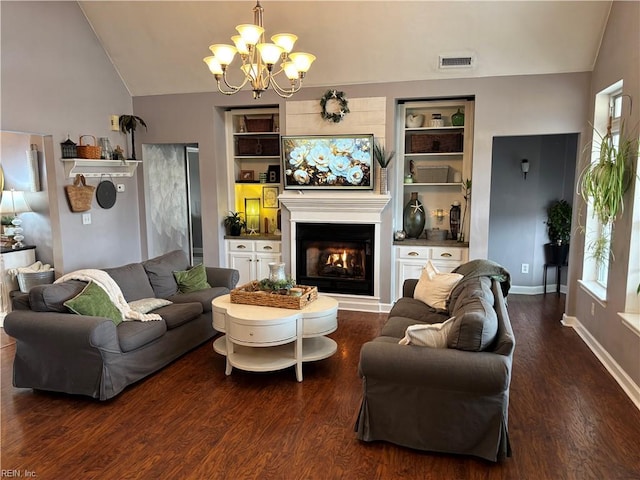 living room with built in shelves, lofted ceiling, dark hardwood / wood-style floors, and a notable chandelier