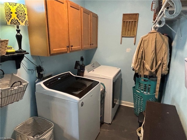 laundry area with washer and clothes dryer and cabinets