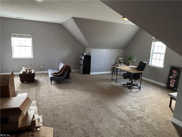 office space featuring carpet floors and vaulted ceiling