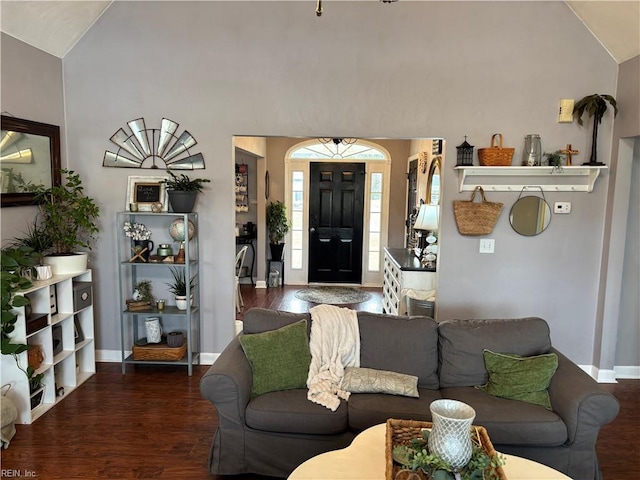 living room with dark hardwood / wood-style flooring and vaulted ceiling