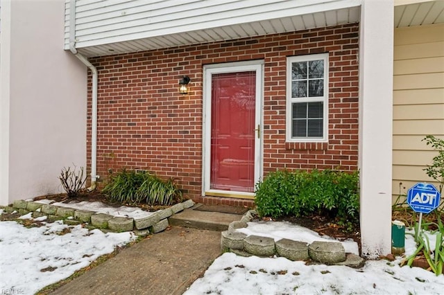 view of snow covered property entrance