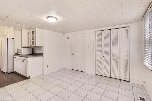 kitchen featuring white appliances and light tile patterned floors