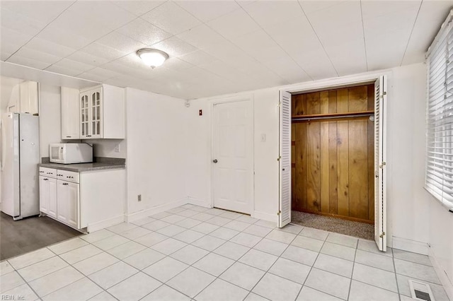 kitchen featuring white cabinets and white appliances