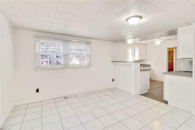 spare room featuring light tile patterned floors and ceiling fan