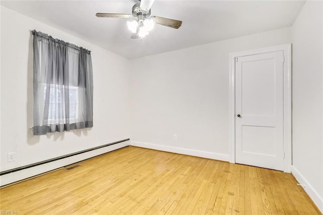 unfurnished room with ceiling fan, light hardwood / wood-style floors, and a baseboard radiator