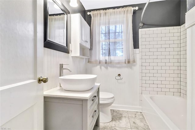 full bathroom featuring vanity, toilet, and tiled shower / bath