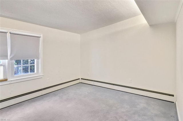 carpeted empty room featuring a textured ceiling