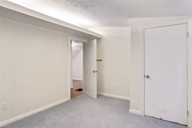 interior space with light carpet, a textured ceiling, and lofted ceiling